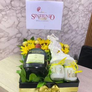 Caja con girasoles, Ferrero Rocher, botella de Buchanas, velas y arcangel